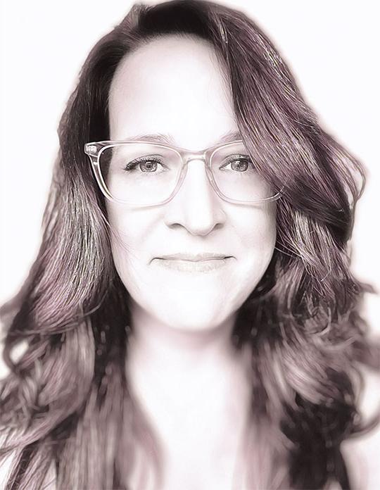 headshot of woman with long dark hair and glasses